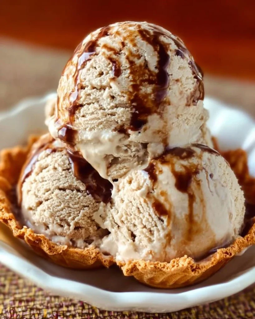 Delicious root beer ice cream in a cone with a fizzy root beer float beside it.