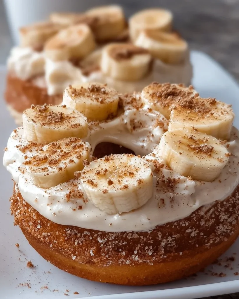 Banana donuts with cinnamon cream cheese frosting on a plate