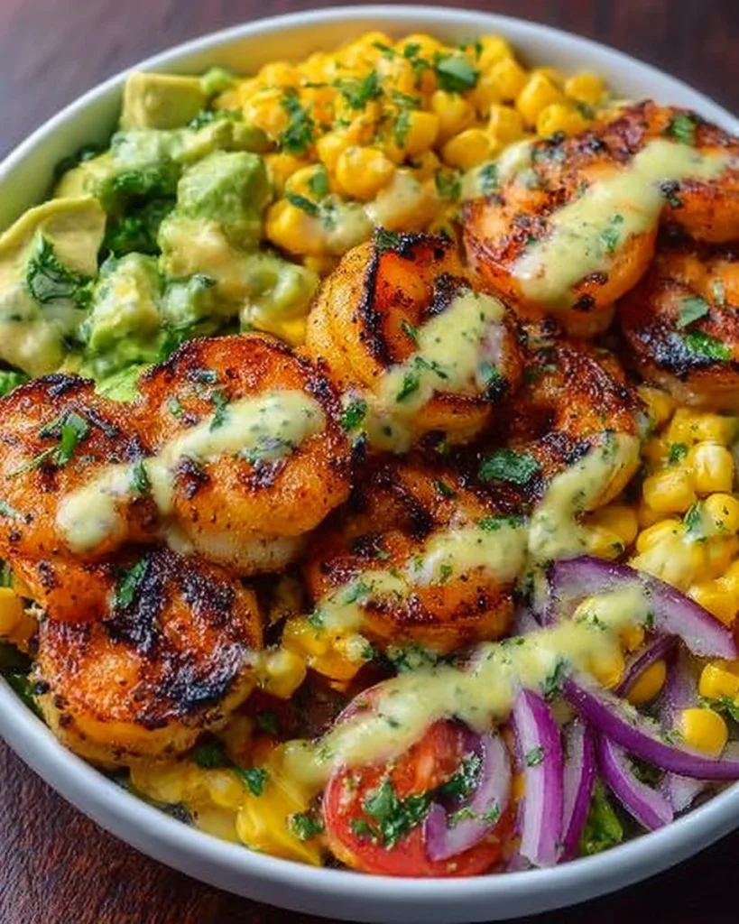 Grilled shrimp bowl with avocado, corn salsa, and creamy garlic sauce