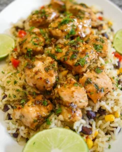 Plate of cilantro lime chicken served with rice and fresh cilantro garnish