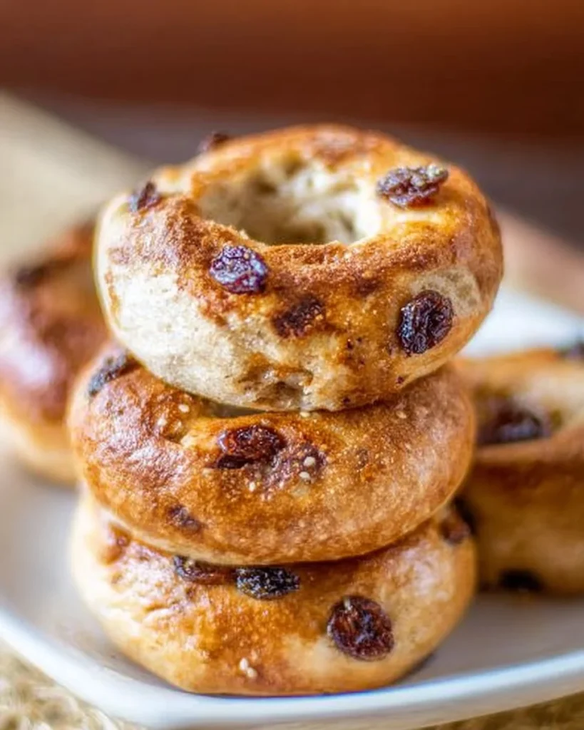 Freshly baked cinnamon raisin bagels with a golden crust and warm spices