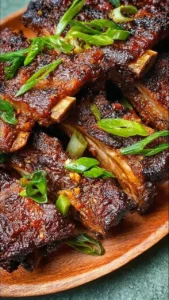 Delicious Chinese spareribs glazed with sauce and garnished, showcasing tender meat.