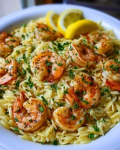 Lemon Garlic Shrimp Orzo served in a bowl with fresh herbs and lemon slices