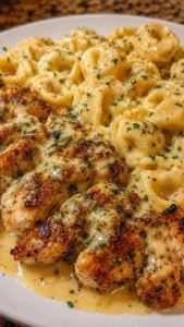 Creamy garlic parmesan tortellini dish served with seared chicken