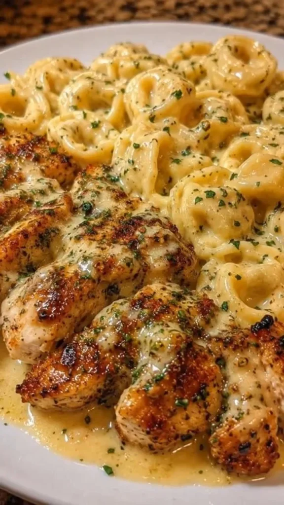 Creamy garlic parmesan tortellini dish served with seared chicken