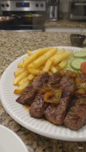 Delicious garlic butter steak bites served with fries and a fresh salad